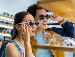 young adults shopping for sunglasses
